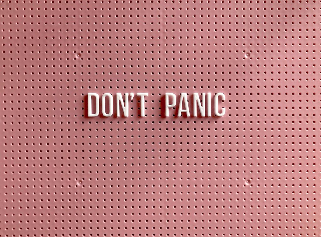 dont-panic pink background white letters bulletin board